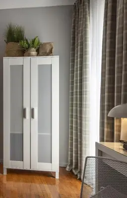 a white cabinet with plants on top in a room at The Apartment 09 in Athens