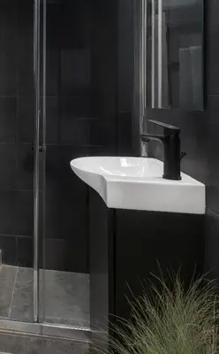 a bathroom with a white sink and a shower at The Apartment 09 in Athens
