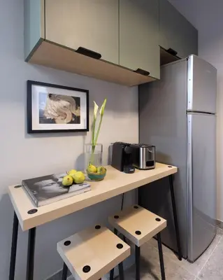 a small kitchen with a counter with a refrigerator at The Apartment 09 in Athens