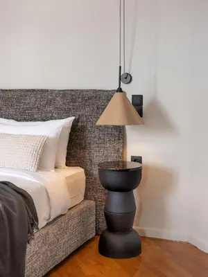 a bedroom with a bed with a lamp next to it at The Apartment 09 in Athens