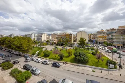 a city with cars parked in a parking lot at The Apartment 09 in Athens