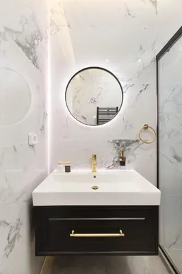 a bathroom with a white sink and a mirror at Alexandra's Unique Apartment in Athens
