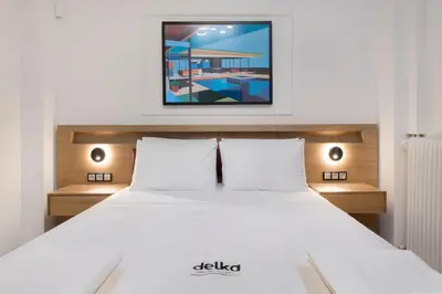 a bedroom with a bed with a picture on the wall at Alexandra's Unique Apartment in Athens