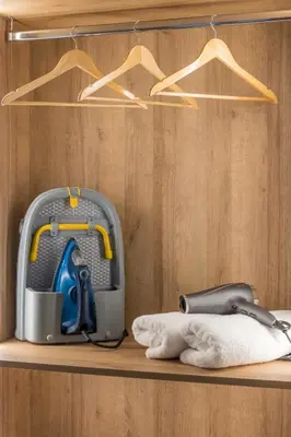 a suitcase sitting on a shelf with a towel at Alexandra's Unique Apartment in Athens