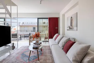 a living room with a couch and a tv at The HostMaster WiseView Acropolis in Athens