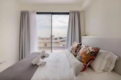 a bedroom with a bed with a large window at The HostMaster WiseView Acropolis in Athens