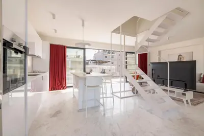 a white kitchen with a white table and chairs at The HostMaster WiseView Acropolis in Athens
