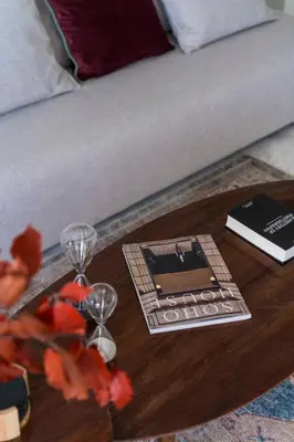 a coffee table with wine glasses and a book at The HostMaster WiseView Acropolis in Athens