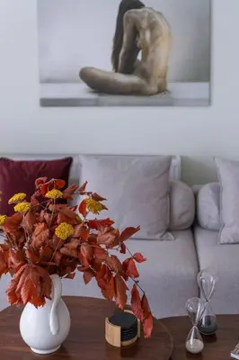a vase with flowers on a table in a living room at The HostMaster WiseView Acropolis in Athens