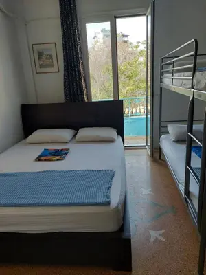 a bedroom with a bed and a bunk bed at SHARED ROOMS LEPENIOTU NEAR ACROPOLIS &MONASTIRAKi in Athens