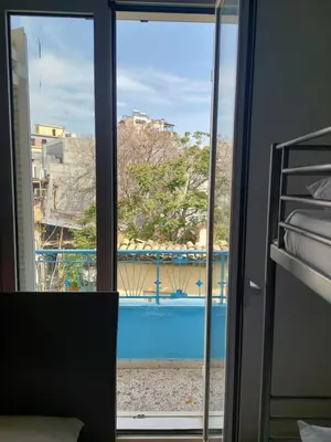 a view of a pool seen through a window at SHARED ROOMS LEPENIOTU NEAR ACROPOLIS &MONASTIRAKi in Athens