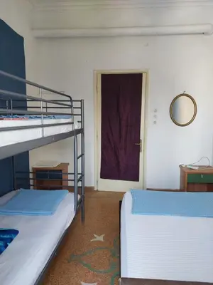 two bunk beds in a room with a door at SHARED ROOMS LEPENIOTU NEAR ACROPOLIS &MONASTIRAKi in Athens