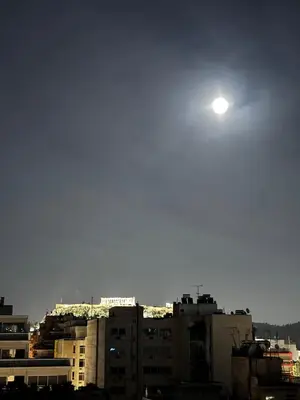 a view of a city with the moon in the sky at Krezias Apartments ST 6 Acropolis View in Athens
