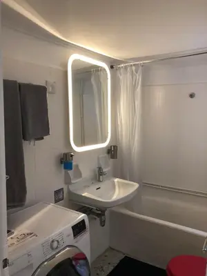 a bathroom with a sink and a mirror and a tub at Krezias Apartments ST 6 Acropolis View in Athens