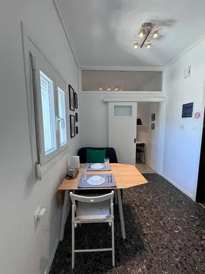 a small room with a table and a chair at Krezias Apartments ST 6 Acropolis View in Athens