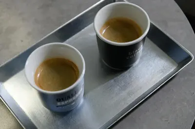 two cups of coffee sitting on a tray at Art Squared in Athens