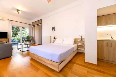 a bedroom with a bed and a living room at Boutique13 Luxury Apartment Glyfada Athens in Athens