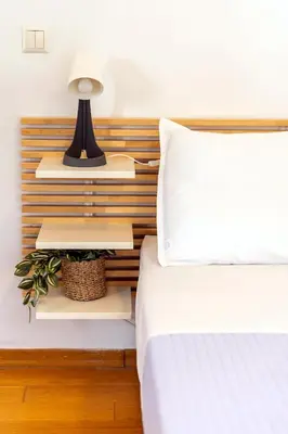 a bedroom with a bed and a lamp and books at Boutique13 Luxury Apartment Glyfada Athens in Athens