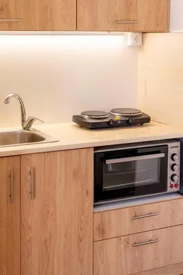 a kitchen with a microwave and a sink at Boutique13 Luxury Apartment Glyfada Athens in Athens