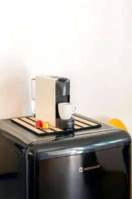 a coffee maker and a cup on top of a microwave at Boutique13 Luxury Apartment Glyfada Athens in Athens