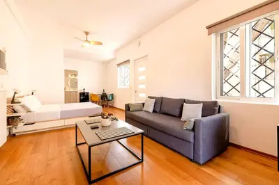 a living room with a couch and a bed at Boutique13 Luxury Apartment Glyfada Athens in Athens