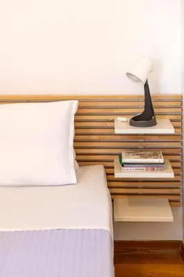 a bedroom with a bed and a lamp on a night stand at Boutique13 Luxury Apartment Glyfada Athens in Athens