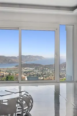 a dining room with a table and large windows at Sea Breeze Retreat with Private Pool in Saronida