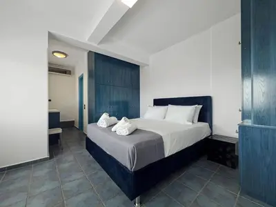 a bedroom with a large bed with towels on it at Sea Breeze Retreat with Private Pool in Saronida