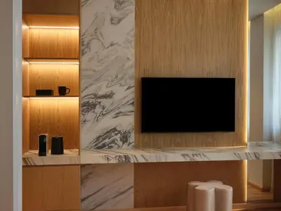 a living room with a tv on a wall at Nur City Suites in Athens