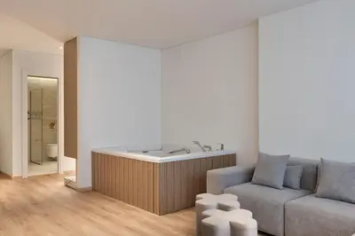 a living room with a tub and a couch at Nur City Suites in Athens