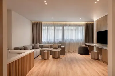 a living room with a couch and a television at Nur City Suites in Athens