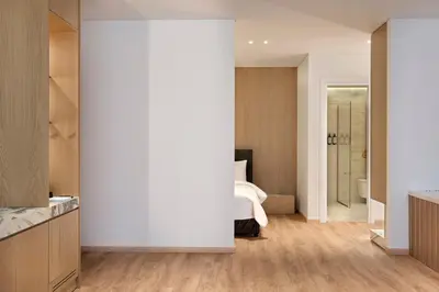 a bedroom with a bed and a bathroom at Nur City Suites in Athens