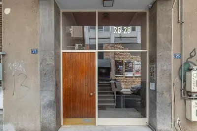 a door to a building with a sign on it at Cozy Penthouse with Balcony in Athens