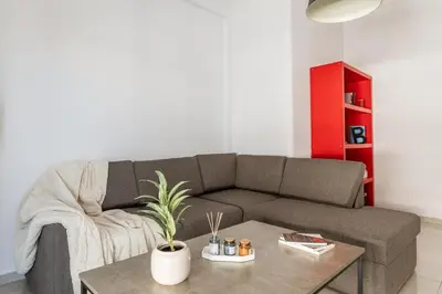 a living room with a couch and a coffee table at Cozy Penthouse with Balcony in Athens