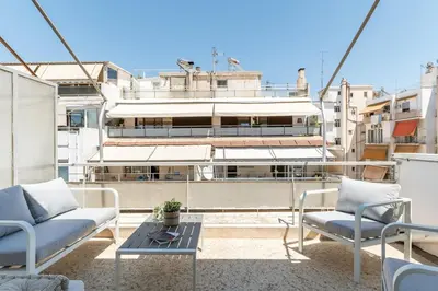 a balcony with chairs and a table and a building at Cozy Penthouse with Balcony in Athens