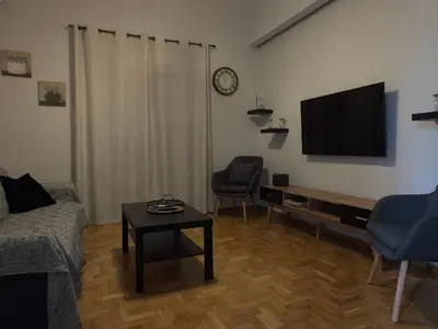a living room with a couch and a tv at Lemon Nest in Athens