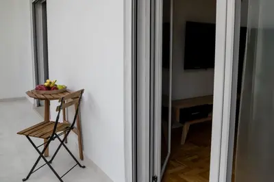 a table with a bowl of fruit in a room at Lemon Nest in Athens