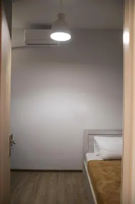 a white room with a bed and a light at Lemon Nest in Athens