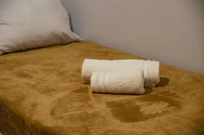a white towel sitting on top of a bed at Lemon Nest in Athens
