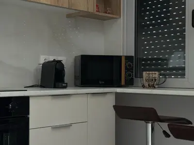 a kitchen with a counter with a microwave and a chair at Lemon Nest in Athens