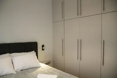 a bedroom with white cabinets and a bed at Lemon Nest in Athens