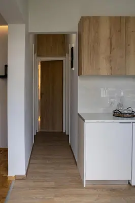 a kitchen with a white counter and a hallway at Lemon Nest in Athens