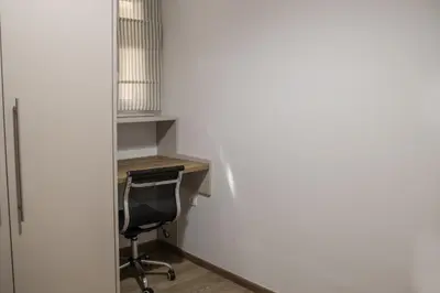 an office with a desk and a chair next to a wall at Lemon Nest in Athens