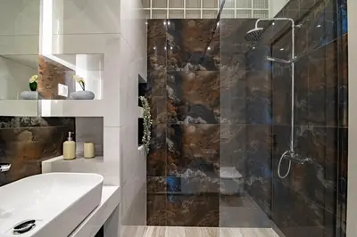 a bathroom with a shower and a sink at Electra's apartments in Piraeus