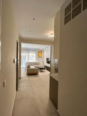 a living room with a couch and a table at Electra's apartments in Piraeus