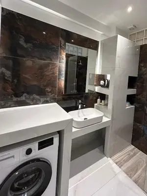 a bathroom with a washing machine and a sink at Electra's apartments in Piraeus