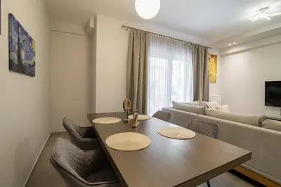 a living room with a table and a couch at Electra's apartments in Piraeus