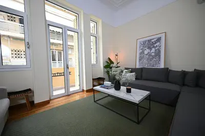 a living room with a couch and a table at The Ilisian Estia in Athens