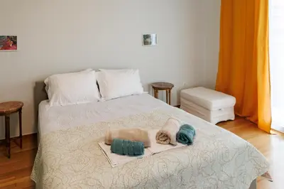 a bedroom with a bed with a towel and two pillows at Apartment in Athens Victoria sguare in Athens