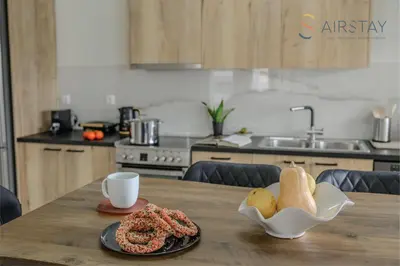 a table with a plate of food and a cup of coffee at Jaax Apartment Airport by Airstay in Spáta